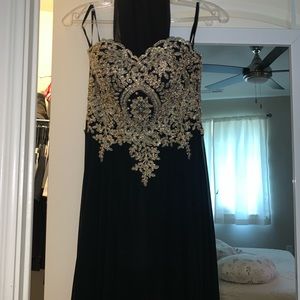 Long black prom dress. Gold shiny beading on top.